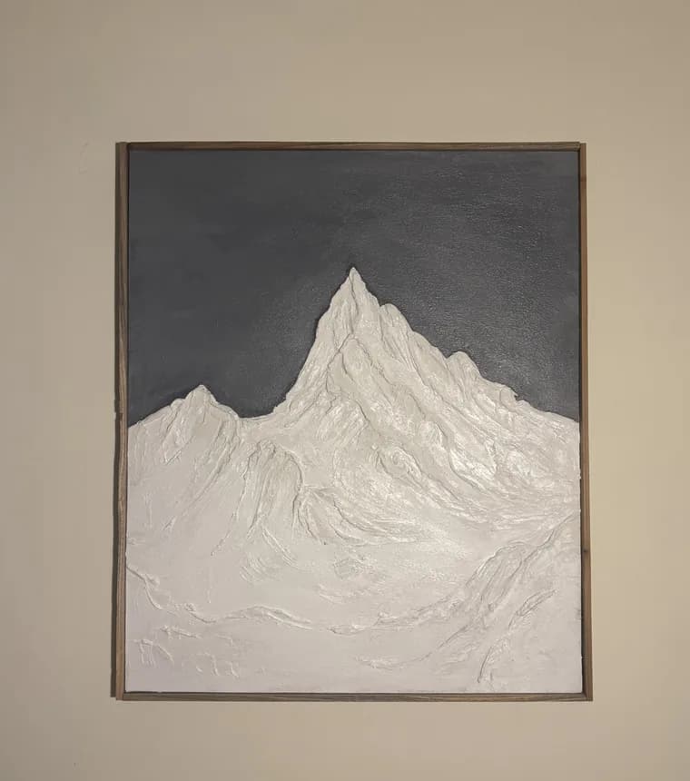 Alps, a raised white mountain in thick texture on a slate canvas, hung on a wall
